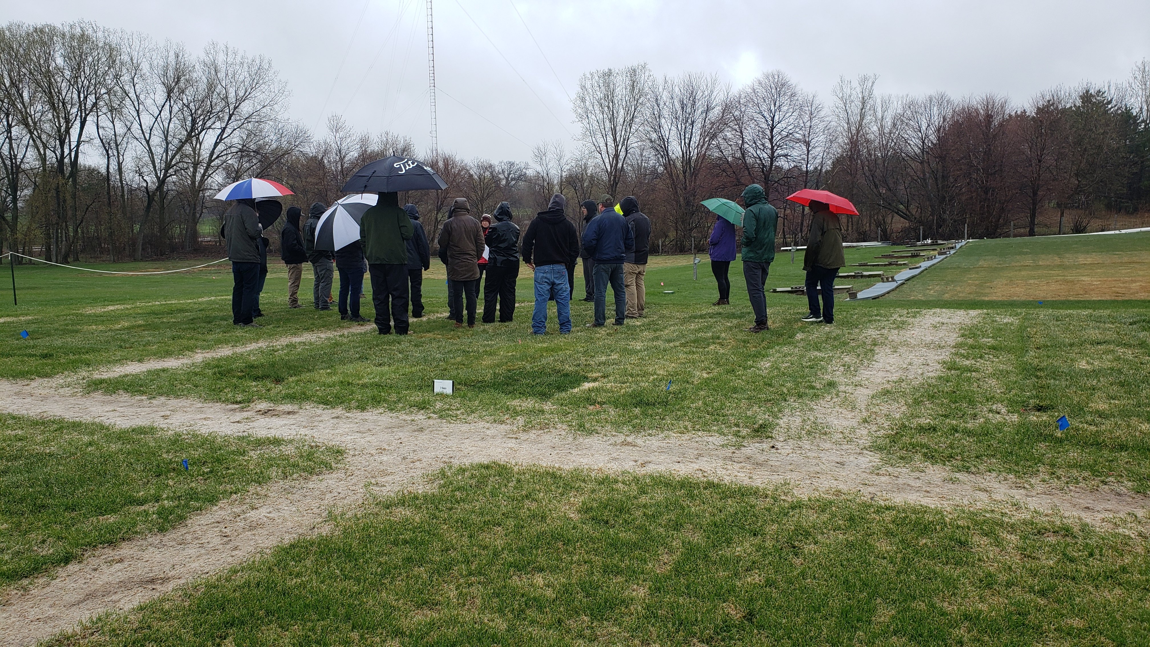 a group of people at turfgrass research plots at a field day
